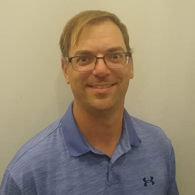 A man with glasses and a blue shirt